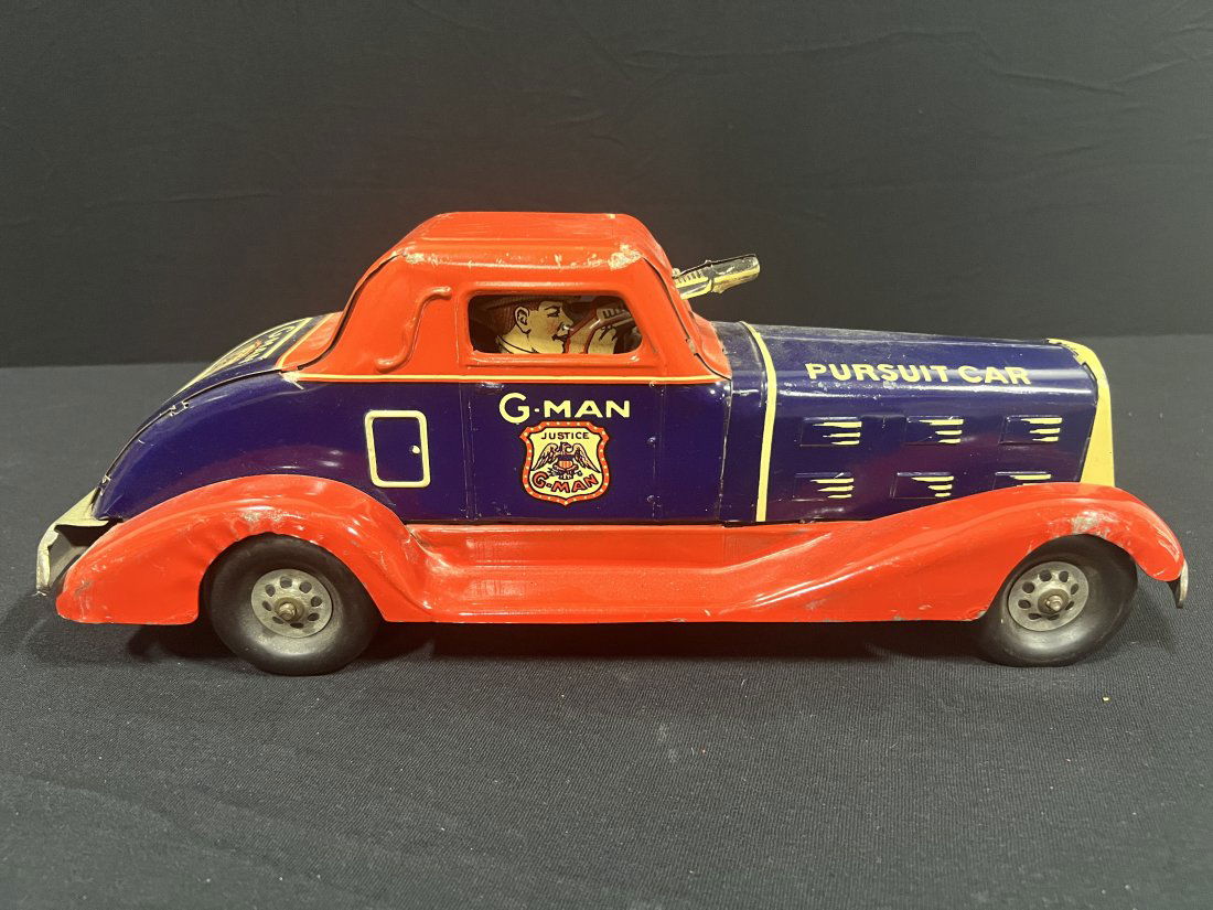 Marx Gman Pursuit wind up toy car police truck: Marx Gman truck Does wind up and makes clicking noise when pushing forward for the gun but doesn?t have enough power with wind up to move it. 14" H x 6" W x 6" D.