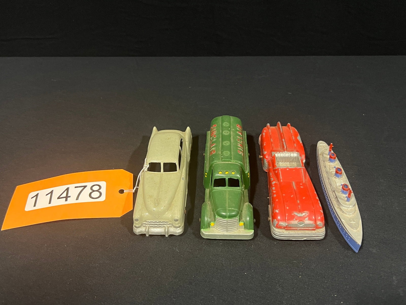 4 Tootsie toy cast metal boat Sinclair Cadillac car: 4 Tootsie cast metal toys. 6" H x 4" W x 2" D.