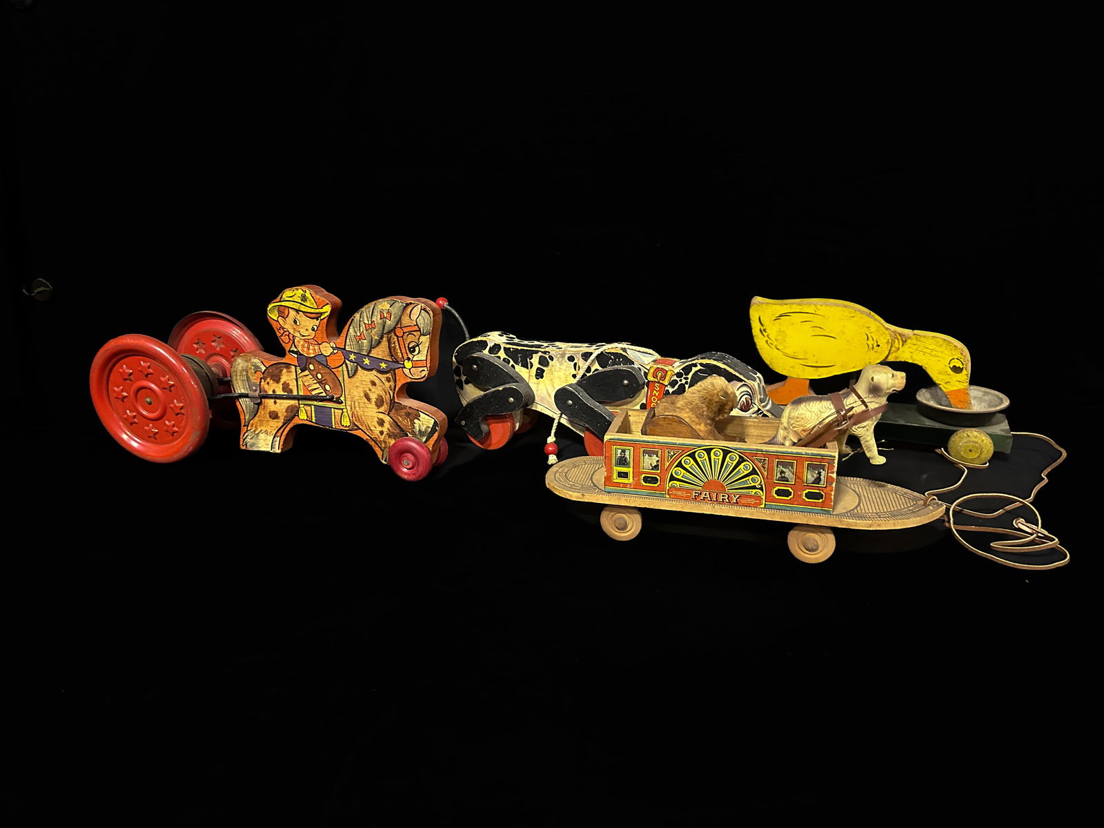 Fisher price snoopy pull toy Toylanders duck wooden cowboy and fairy sled with dogs pull toy: Multiple pull toys from different manufactures. Wooden cowboy dings while being pulled. Wooden Duck, snoopy and fairy skateboard. PLEASE NOTE, THERE IS ONLY ONE WAY TO PAY FOR ONLINE ITEMS IN THIS AUC