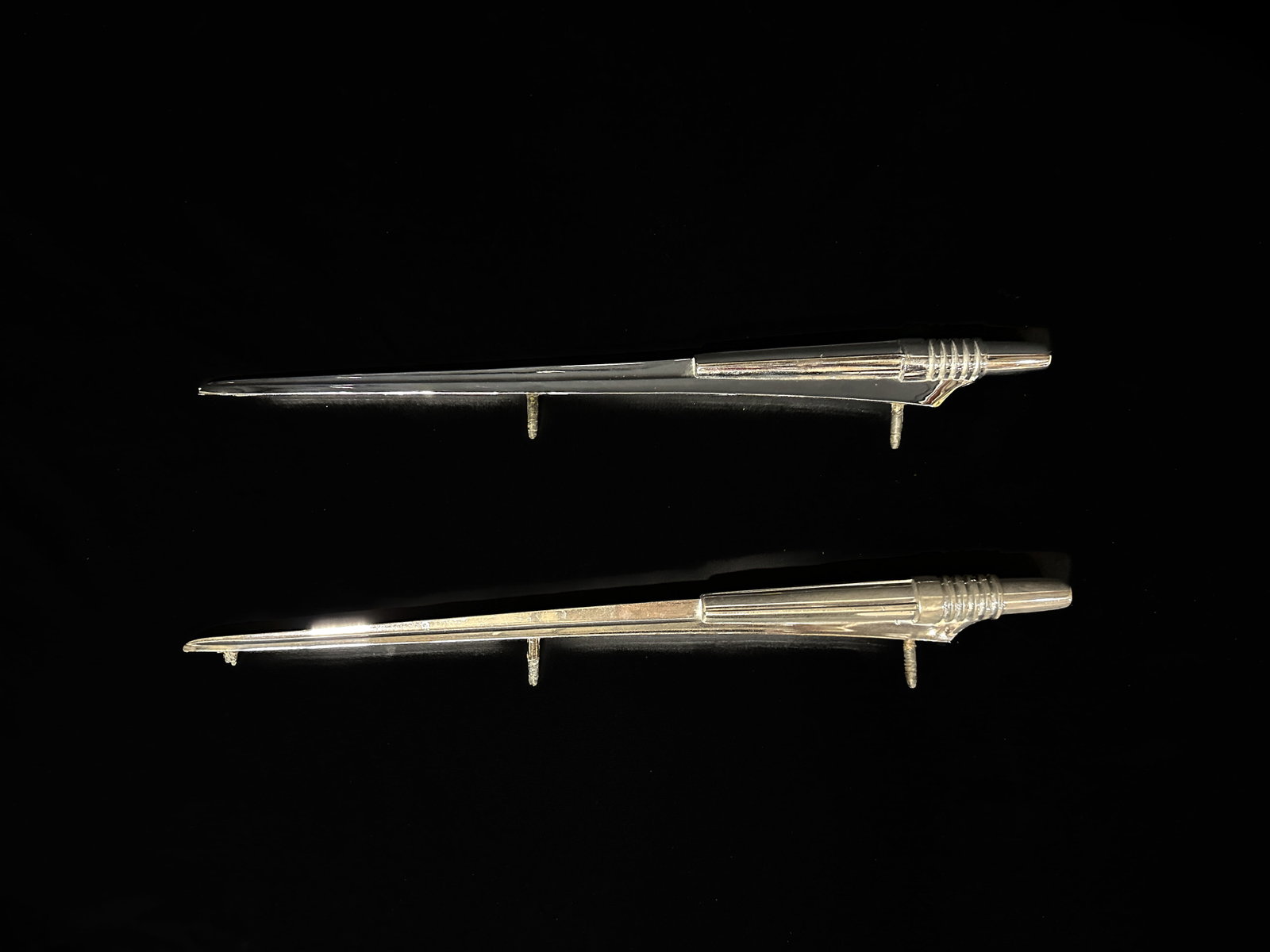 1961 Pontiac Bonneville Fender Rocket ornament trim molding: Both have a broken 3rd stand on the back. Some pitting on both. PLEASE NOTE, THERE IS ONLY ONE WAY TO PAY FOR ONLINE ITEMS IN THIS AUCTION WHICH IS THROUGH LIVE AUCTIONEERS. THIS IS THE MOST SECURE ME