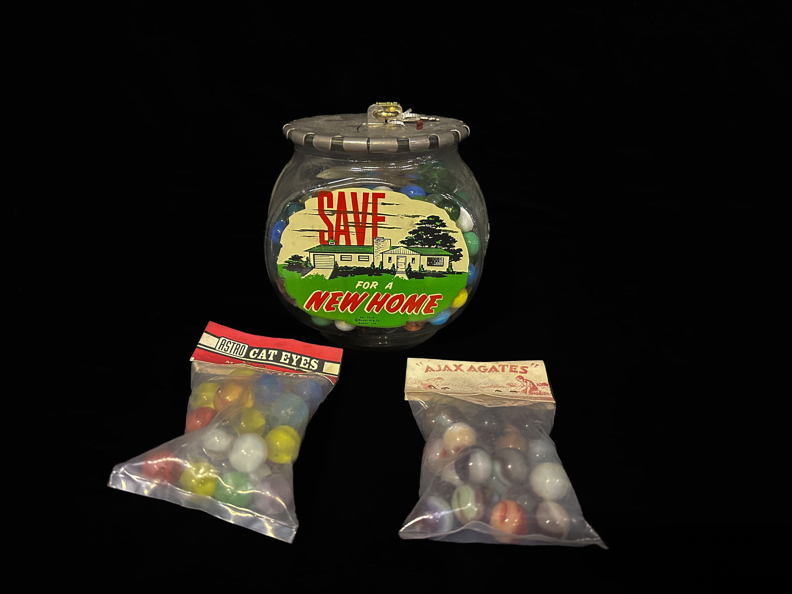 Astro Cat Eyes Ajax Agates Marble savings bank: 3 lots of marbles. PLEASE NOTE, THERE IS ONLY ONE WAY TO PAY FOR ONLINE ITEMS IN THIS AUCTION WHICH IS THROUGH LIVE AUCTIONEERS. THIS IS THE MOST SECURE METHOD OF PAYMENT. MAKE SURE YOUR LIVE AUCTIONE