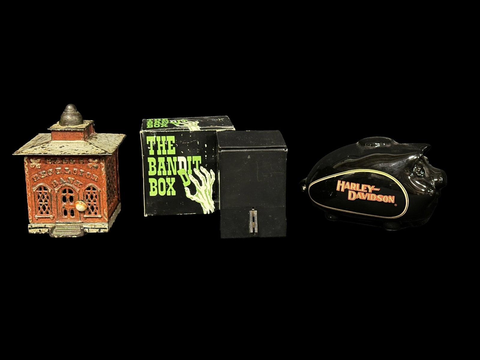 Hall's excelsior cast iron bank by Stevens. Harley Davidson Piggy bank. Bandit box bank: 3 piggy banks. A cast iron bank by J & E stevens, Harley piggy bank and bandit box bank. PLEASE NOTE, THERE IS ONLY ONE WAY TO PAY FOR ONLINE ITEMS IN THIS AUCTION WHICH IS THROUGH LIVE AUCTIONEERS. T