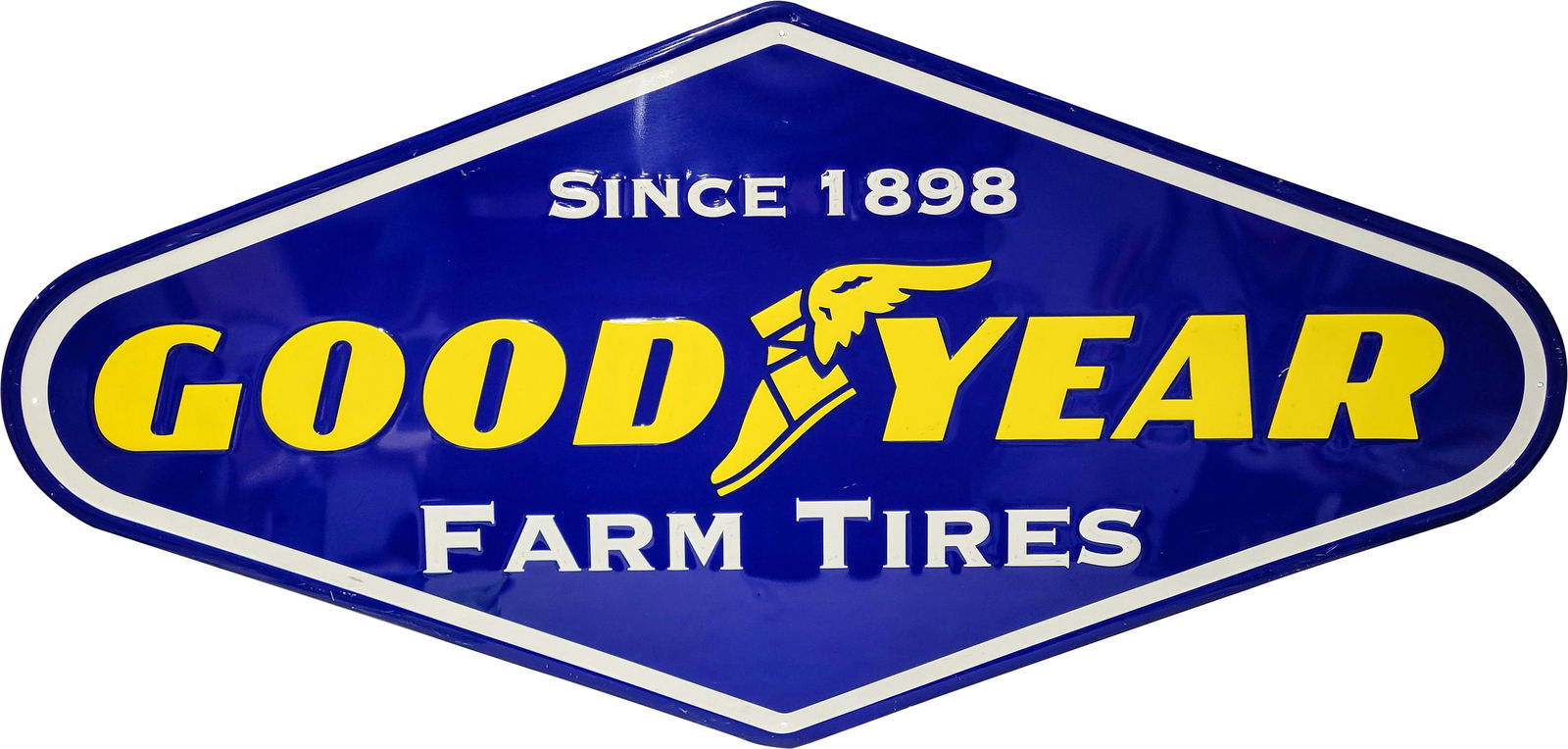 Goodyear Farm Tires Embossed SS Sign: 72" x 36" single-sided embossed sign features the Goodyear winged boot logo with bright colors and a high shine finish. The white lettering at the top exhibits some light scratches, while the lower le