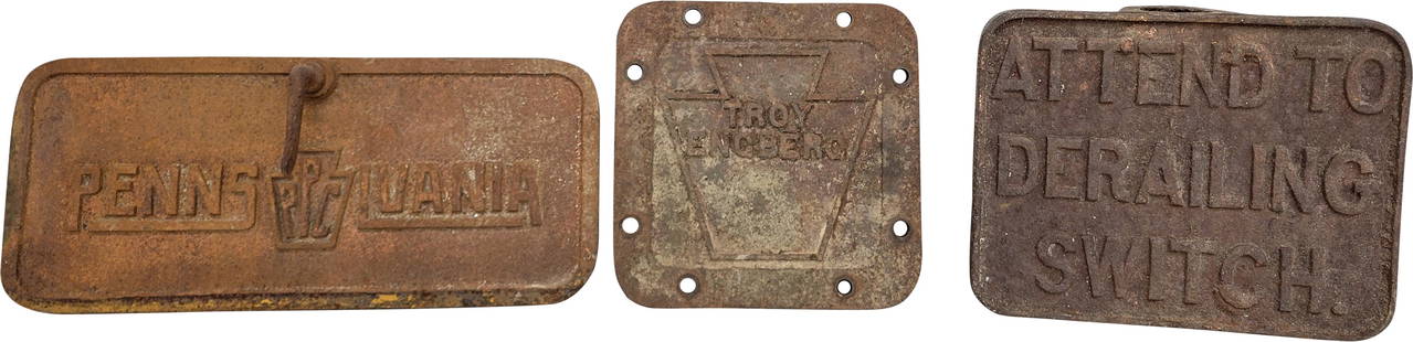 Railroad Derailing Switch, Troy Engberg, and Pennsylvania Cast Iron Plaque Signs: Lot of 3 cast iron embossed signs which include a 10" x 8" Attend To Derailing Switch sign, a 8" x 8" Engberg sign, and a 14.5" x 6.5" Pennsylvania sign. All 3 plaque signs display typical signs of ge
