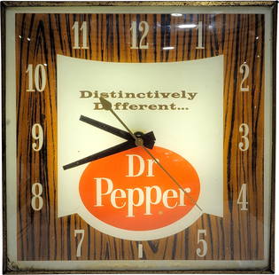 Dr Pepper Distinctively Different Pam Advertising Clock: 15" illuminated clock featuring a glass face, metal trim, and housing. The clock works and lights when plugged in. There are areas of flaked paint along the bottom interior edge and there is a scratch