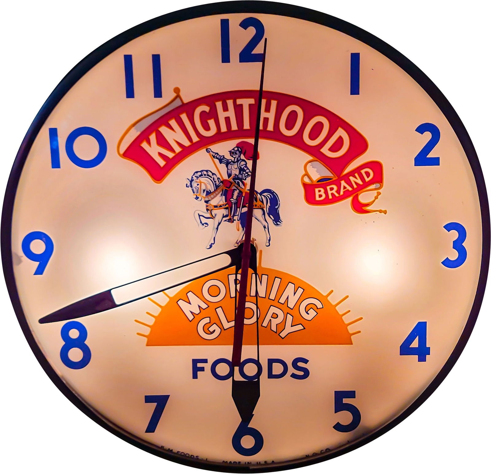 Knighthood Brand Morning Glory Foods Light Up Advertising Clock: 15" illuminated clock with glass face and Masonite housing. The clock lights when plugged in. The hour hand does not work. The second hand and minute hand appear to be functioning properly. The clock