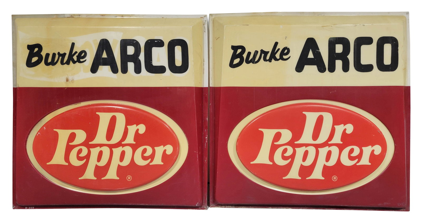 Pair of Dr Pepper Burke Arco Plastic Sign Skins: 60" x 60" x 6" each, Pair of embossed plastic sign skins displays sign of wear with cracks, scratches, stains, and toning. One sign panel has the faint image of a previous advertisement visible behind