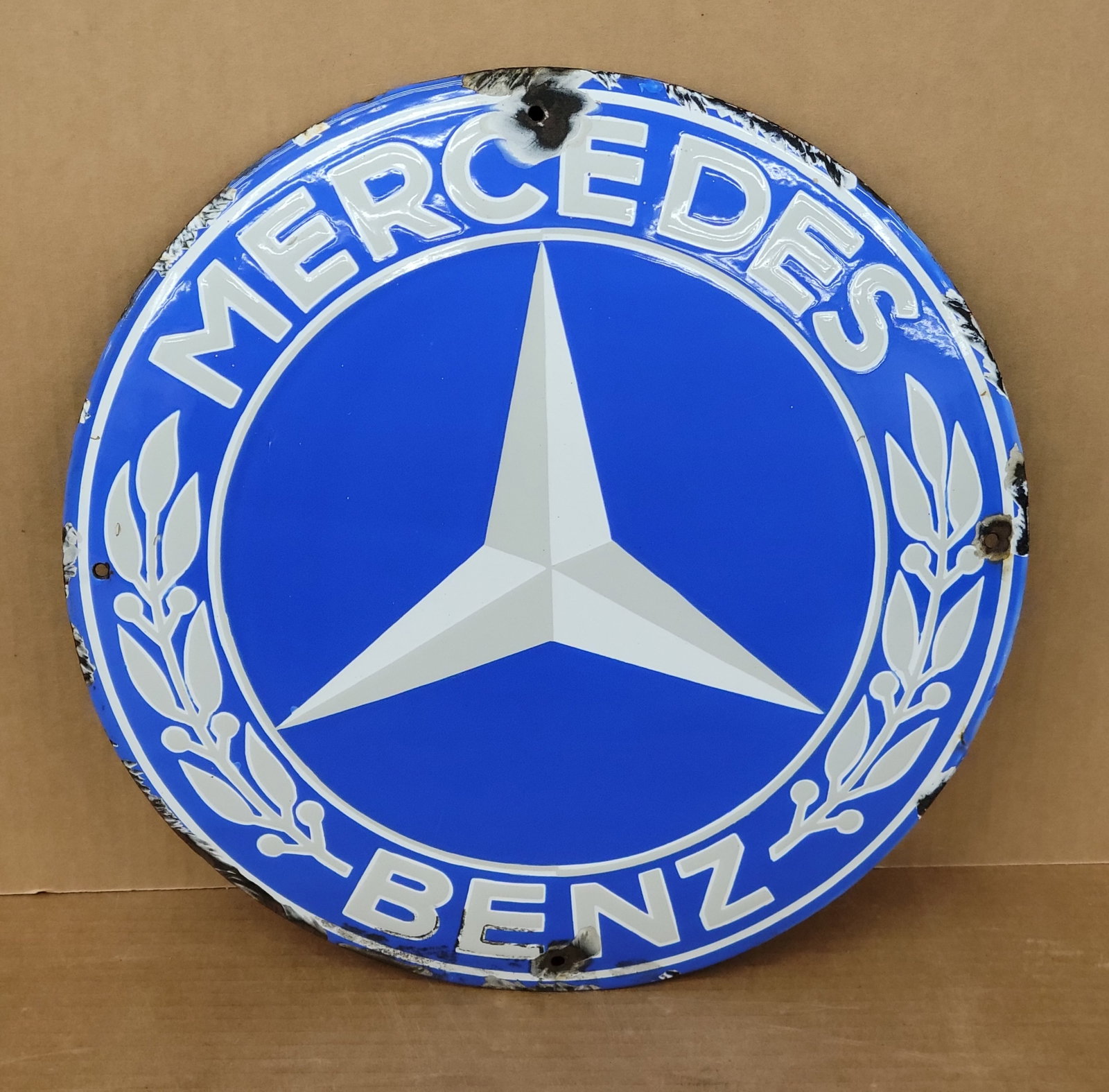 Mercedes Benz Single Sided Porcelain Convex Button Sign: 15.5" SSP sign displays bright colors and high gloss with porcelain chips around the perimeter and mounting holes. Rated 8.25