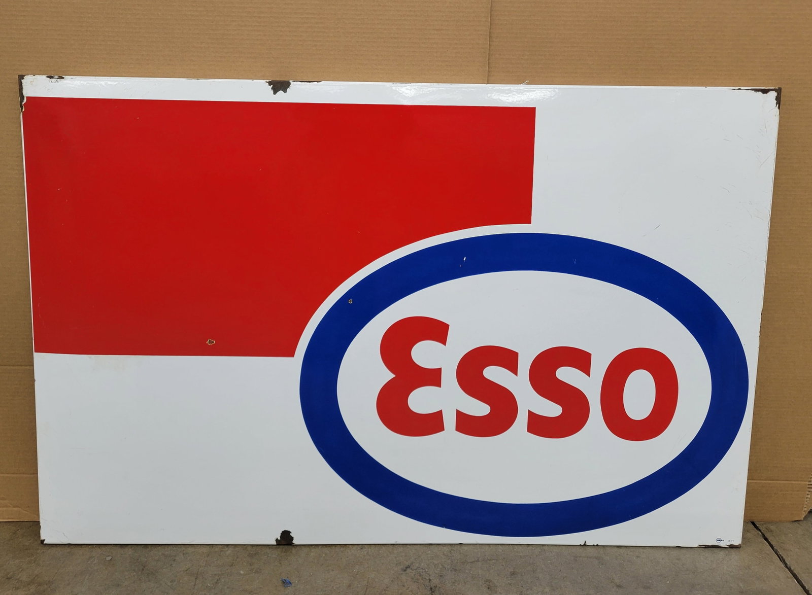 Esso Single Sided Porcelain Sign: 56.5" x 37" SSP sign has very good color and gloss. There are few very small chips in the field. The perimeter has several small bends and there are large porcelain chips.