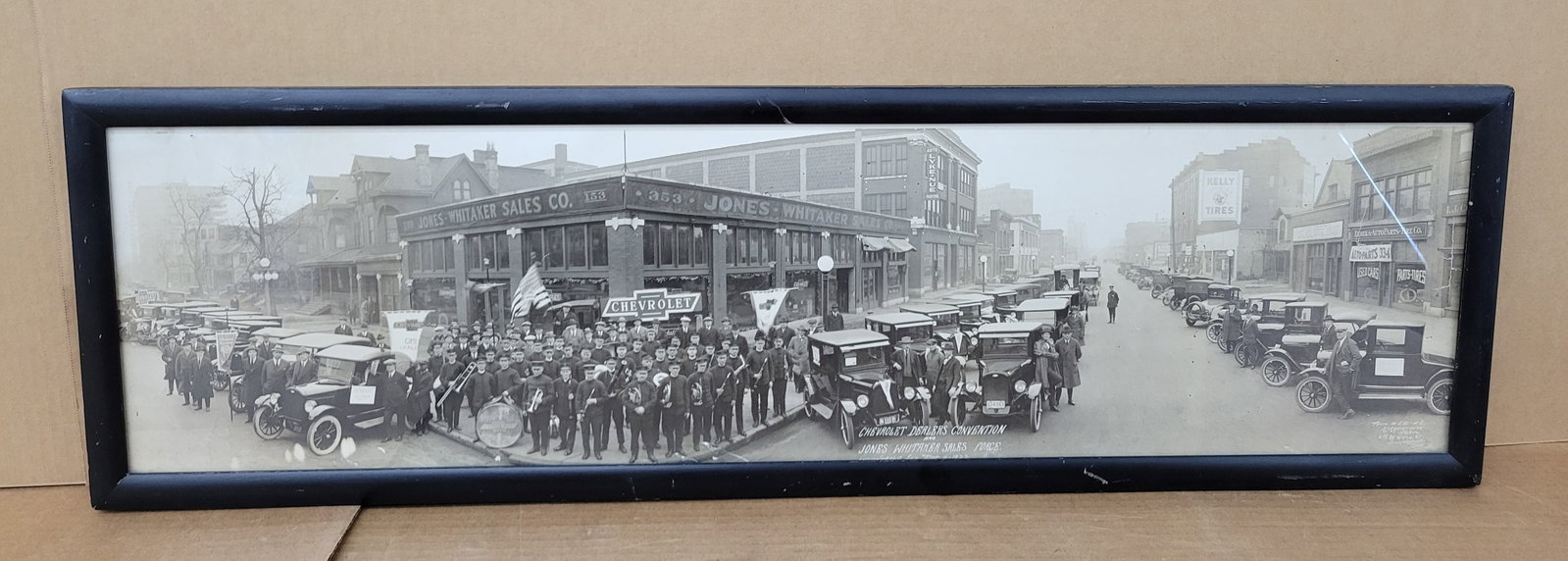 1922 Chevrolet Dealer's Convention Framed Photo: 38.75" x 11.5" photograph from 1922 captures the Chevrolet Dealers Convention alongside the Jones Whitaker Sales Force based in Indianapolis, Indiana. The image features the Chevrolet Motor Co. Band, 