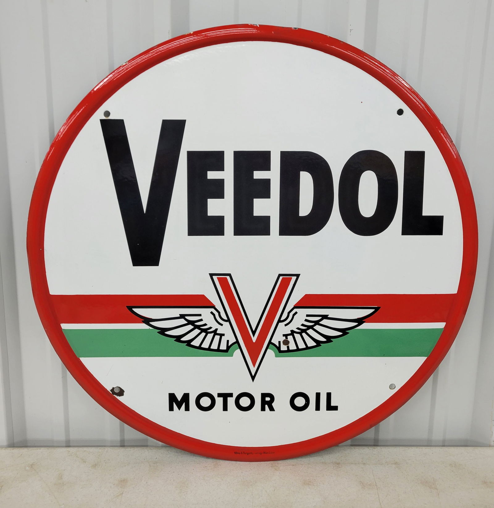 Veedol Motor Oil Single Sided Porcelain Sign: 29.5" SSP sign with winged logo exhibits excellent color and gloss with a small bullet ding in the right wing and chips around the bottom left mounting hole. The self framed perimeter has minor wear w