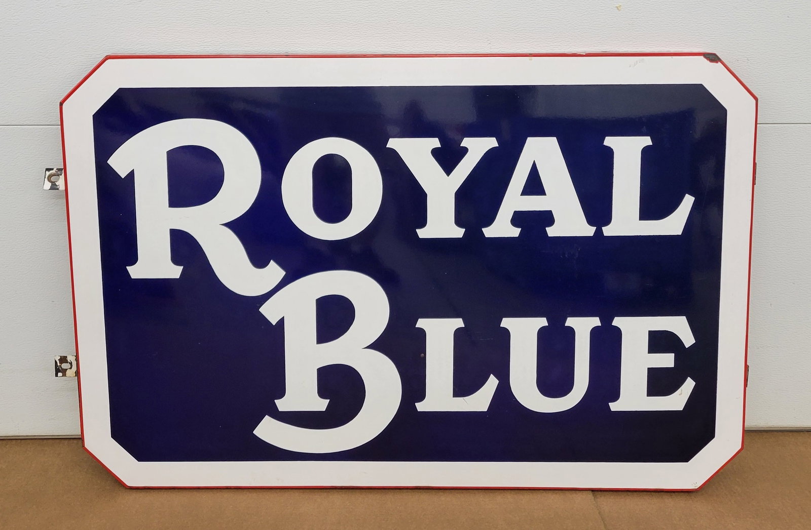 Royal Blue Single Sided Porcelain Sign: 45" x 30" x 1.5"d SSP sign shows well with strong colors and high gloss. There are small chips along the lower edge with a few around the outer perimeter. A 1" chip is visible at the top right corner.
