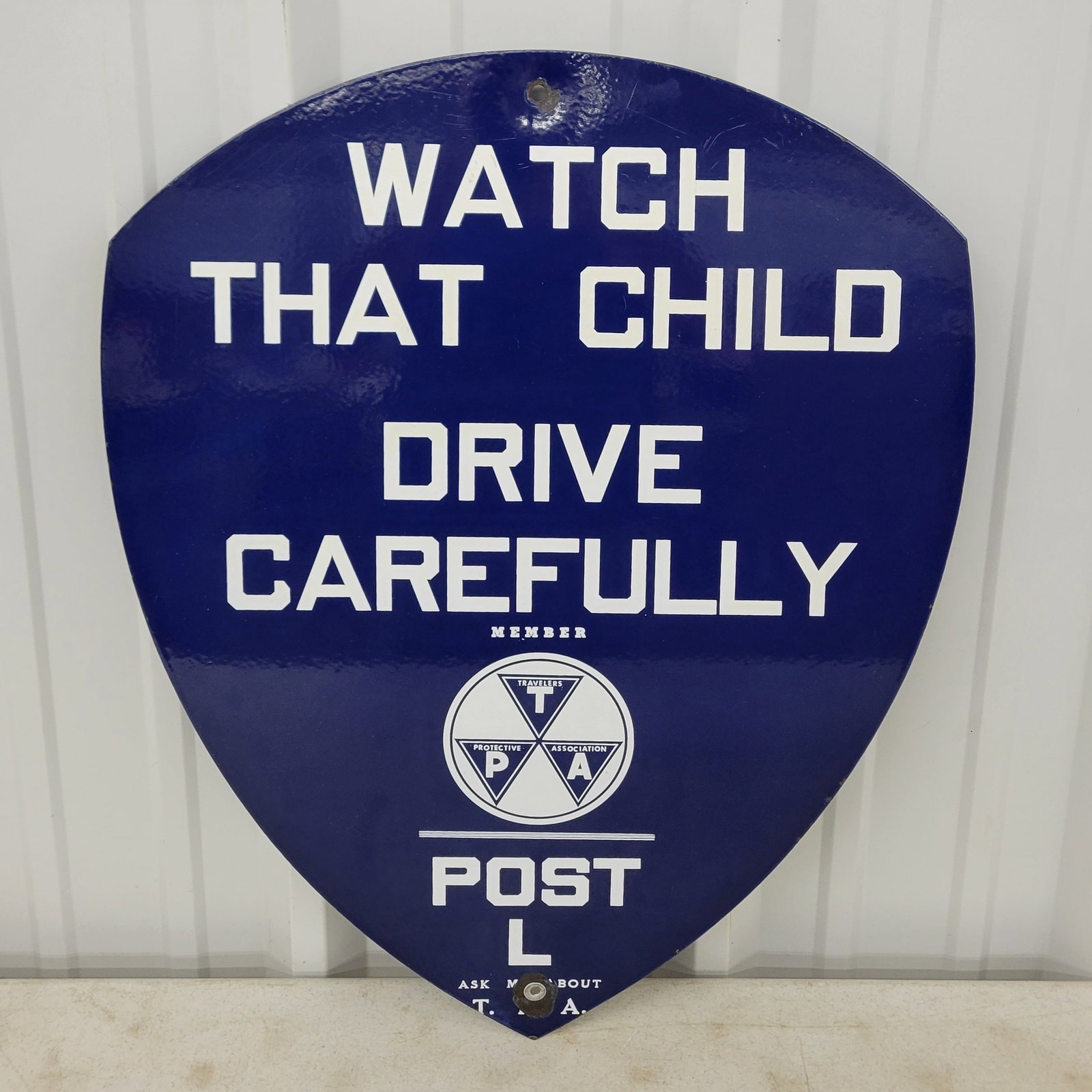 Travelers Protective Association Watch That Child Sign: 22" x 28" single sided porcelain sign displays well with excellent color and gloss. Minor scratches are visible in the upper field and the mount holes have small chips. POST L. Rated 9.0.