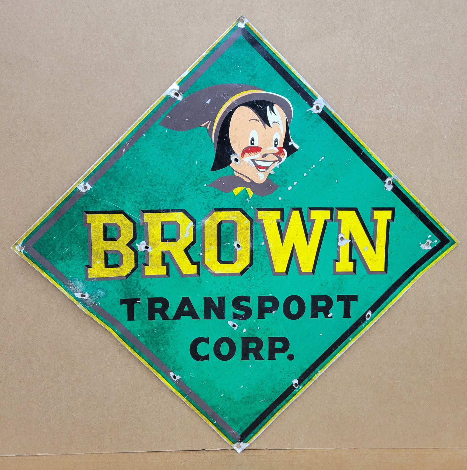 Brown Transport Corp. Single Sided Tin Sign: 27" x 27" SST sign has wear with discoloration and stains. There are multiple holes and bends throughout the sign.