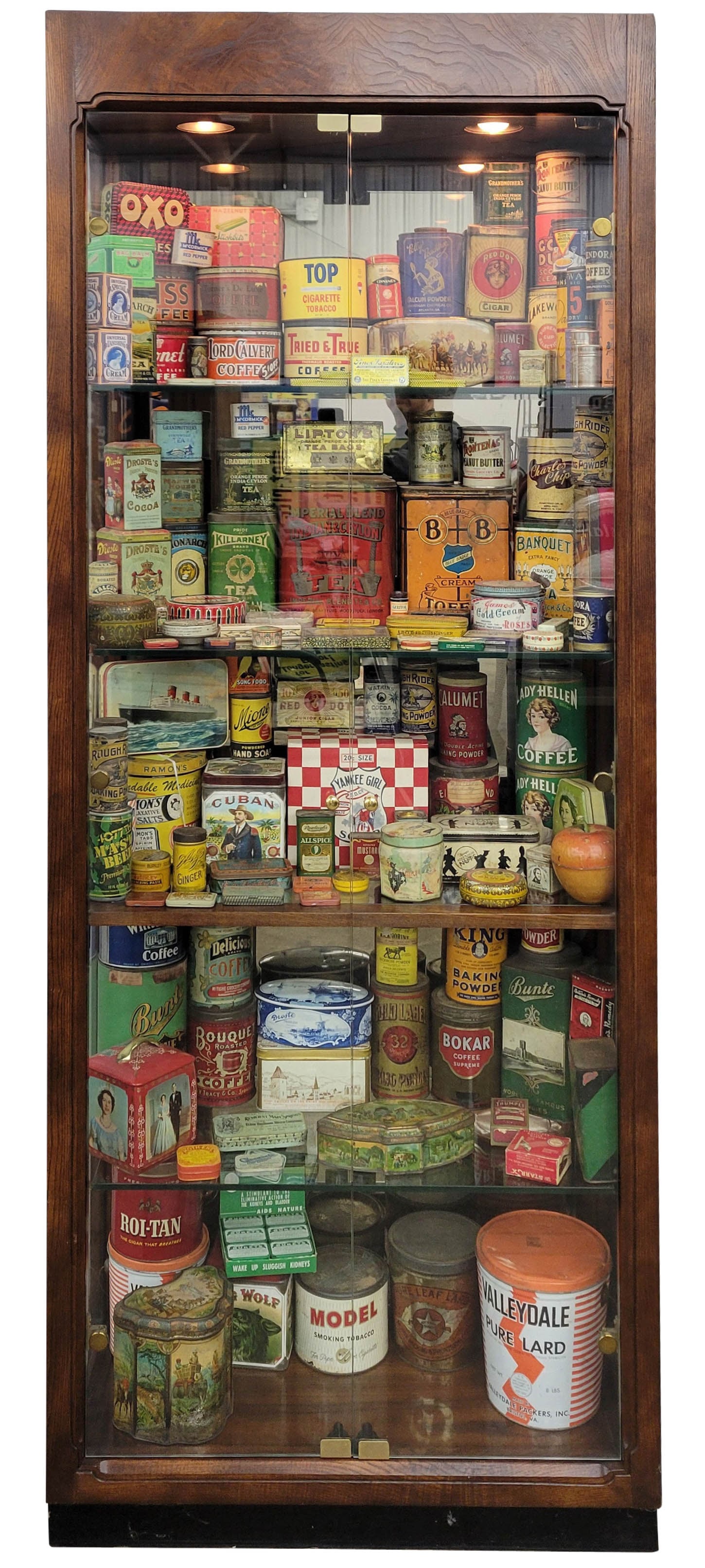 Large Country Store Tin Collection In Lighted Showcase #1: A stunning wooden showcase measuring 32"w x 14.75"d x 81"h, featuring four glass shelves, houses a collection of around 140 assorted tins. Some of the notable brands represented include: Huntley and P