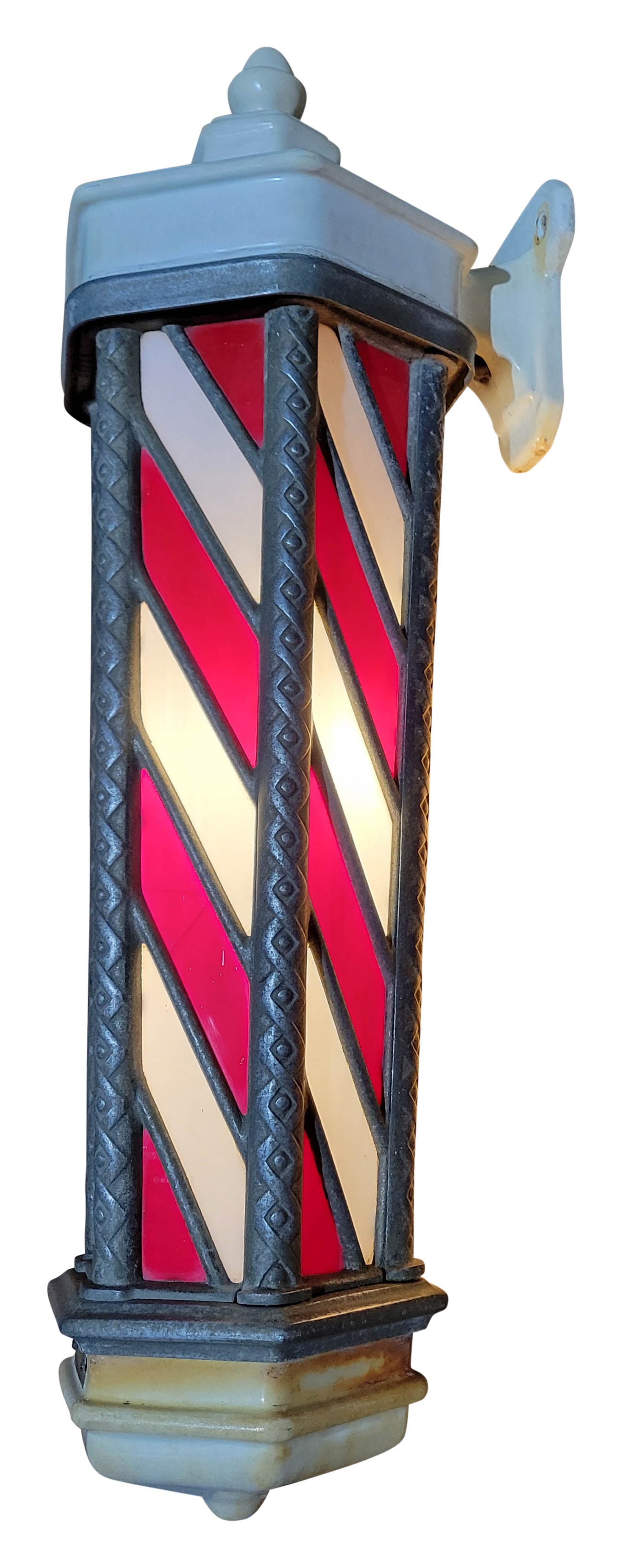 1920's Koken Stained Glass Barber Pole Model 140: 33"h antique Koken #140 barber pole from the 1920s showcases illuminated red and white stained glass. It is intended for wall mounting and features six sides. One panel on the rear is designed to stay