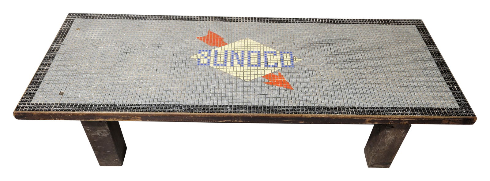 Sunoco Tiled and Wood Coffee Table: 60" x 22" x 14.5" wooden table showcases a tiled surface with the Sunoco logo. It exhibits signs of wear, including two small missing tiles on the top and scratches around the wooden edges and legs. O