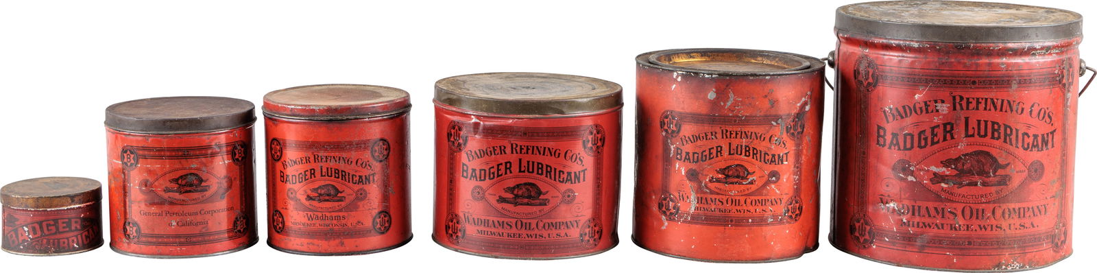 Fantastic Group of Six Wadhams Badger Lubricants Metal Advertising Cans: Group of six empty metal cans with lids. The cans display well and feature good color and shine with Badger graphics. The cans display well with some having areas of general wear with discoloration an