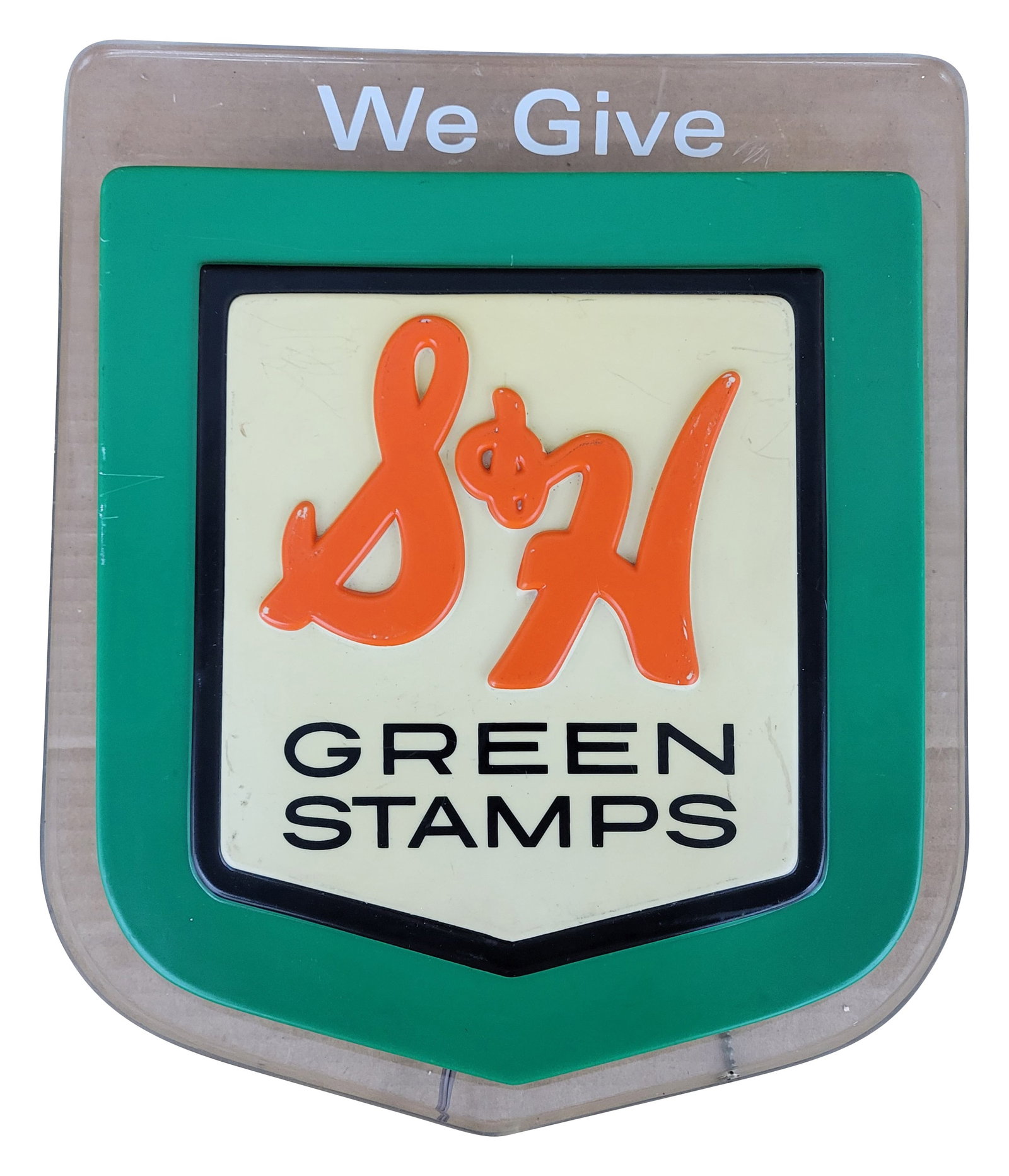 We Give S & H Green Stamps Light Up Advertising Sign: 11" x 13" embossed sign features an embossed plastic face with a clear plastic housing. The plastic face has good color with a few scuffs and scratches. When plugged in and turned on, the light on the