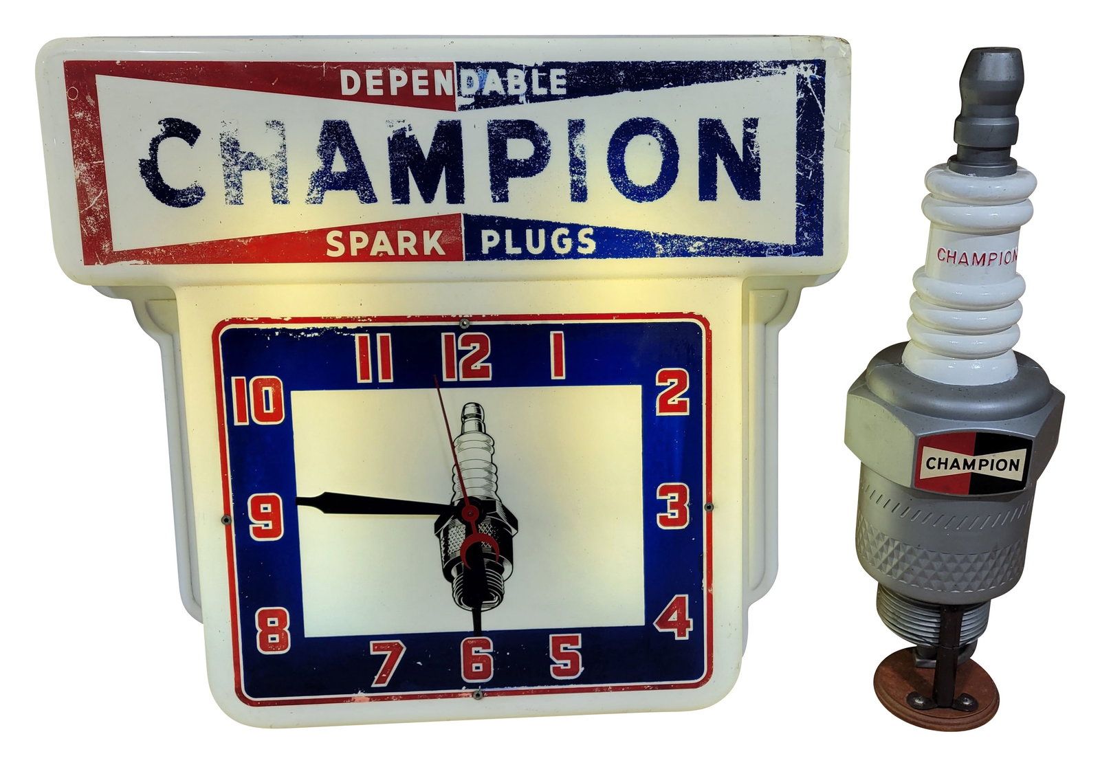 Champion Spark Plugs Light Up Clock and Store Display: Lot of 2 features a 26" x 23.5" x 35" single sided plastic clock that has worn graphics at the top and light wear on the clock face. There is a small hole on the upper right corner that has been taped