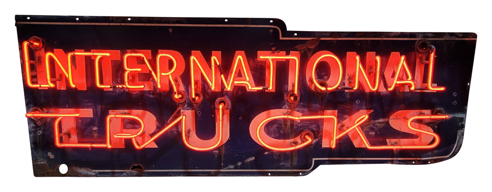 International Trucks DST Factory Neon Sign: 24" x 68" x 14", Working DST factory neon sign with the original metal can has good color and shine. The display has surface wear with areas of fading and older repaint. The display has paint chips an