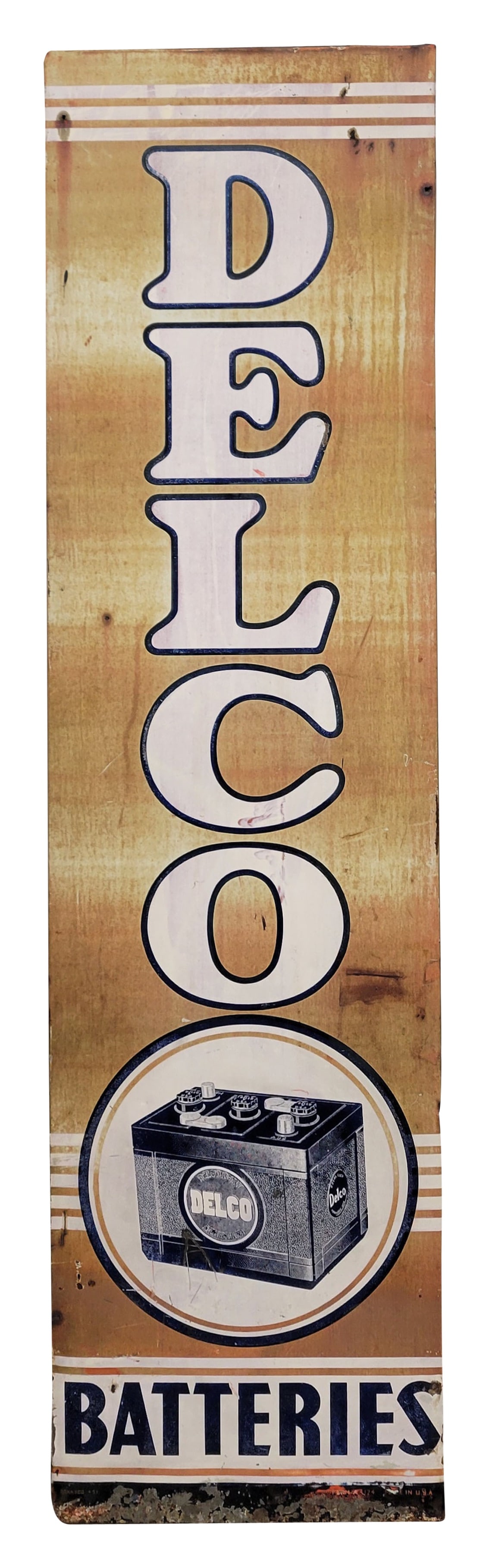 Delco Batteries Single Sided Tin Sign: 18.5" x 70.5" vertical SST sign displays wear and age throughout with fading, dings, scratches and light rust. The bottom has missing paint and it has a wood frame on the back. Donasco.