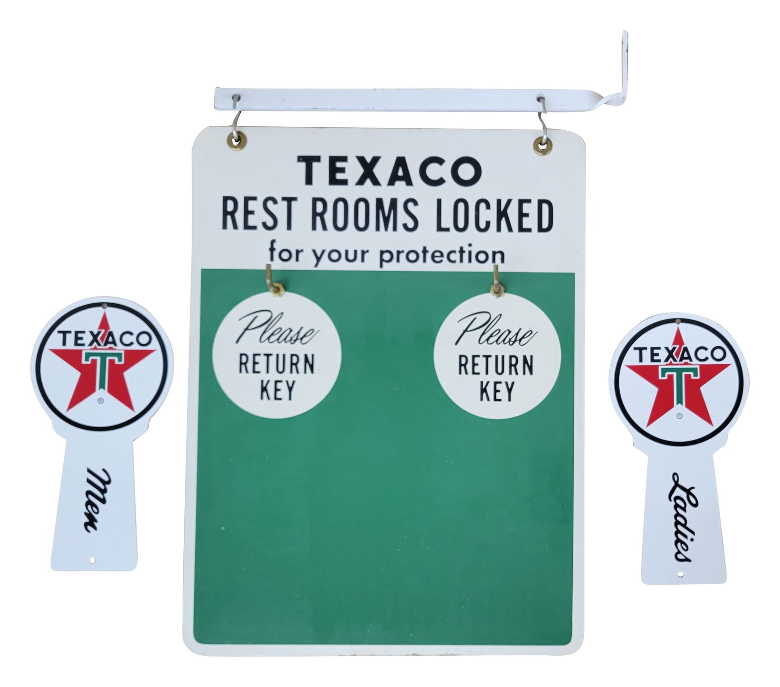 Texaco Rest Rooms Locked Service Station Sign: 9.5" x 14" DST sign displays well with excellent color and gloss. The sign includes Men and Ladies die cut SST key fob holders and also a hanging bracket, all in excellent condition.