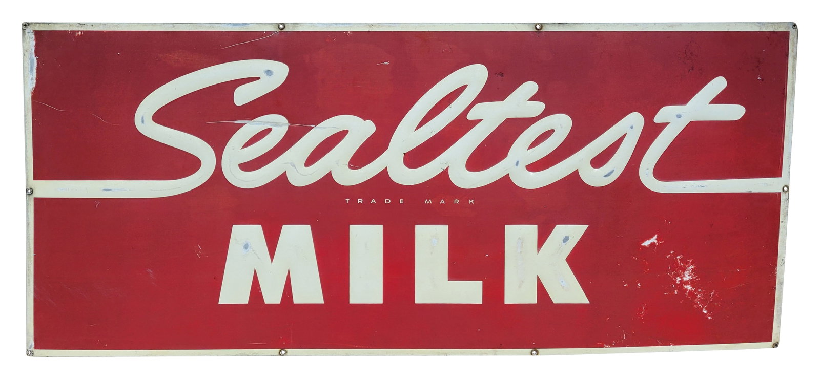 Sealtest Milk Embossed SST Sign: 49" x 21.5" single sided tin sign features embossed letters. There are heavy scratches in the field with wear on the embossed letters. Edge wear visible with light rust at the mounting holes.