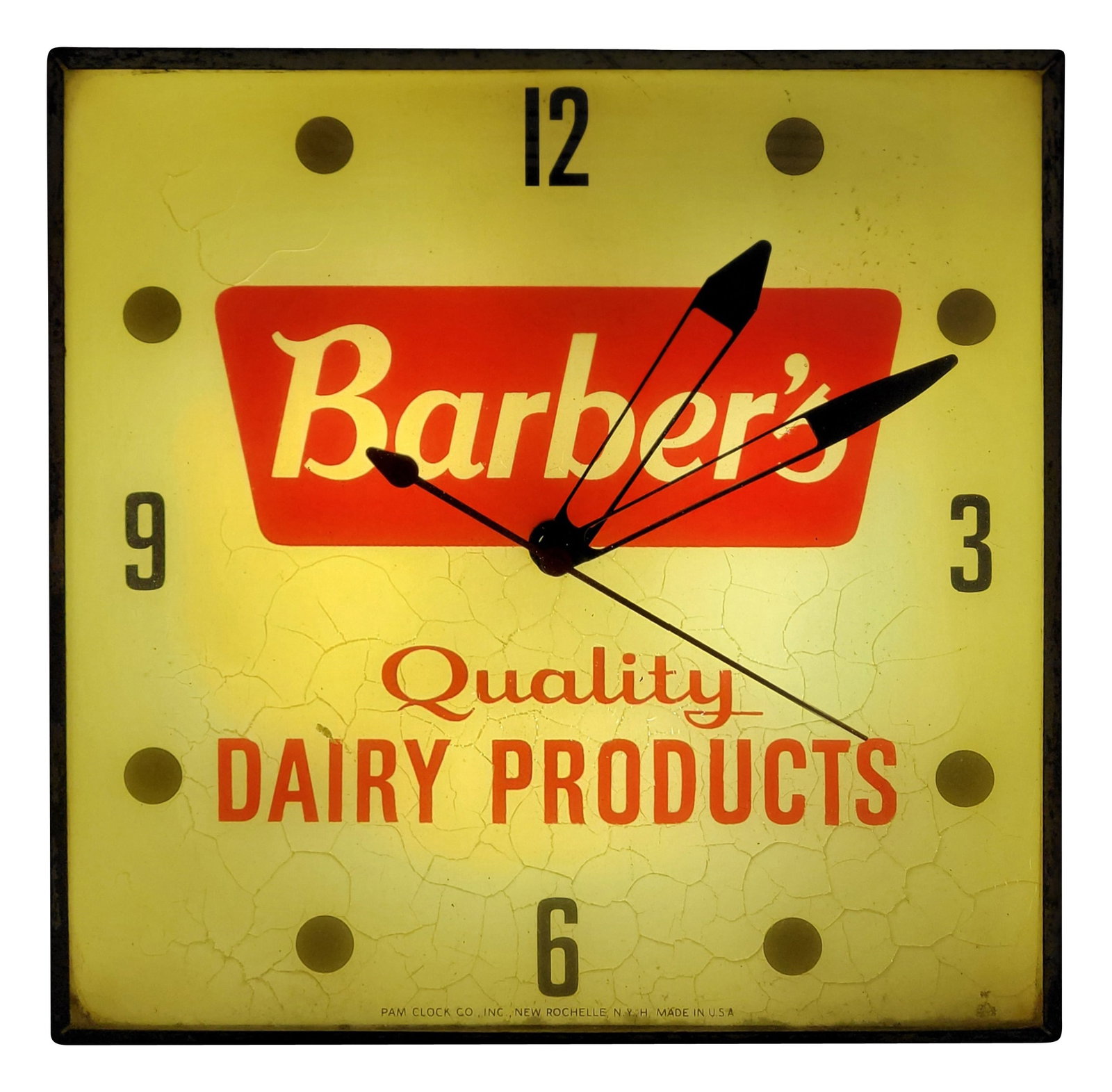 Barber's Quality Dairy Products Light Up Pam Advertising Clock: 15.25" x 15.25" working illuminated clock features a glass face and metal can. The inner glass advertising face exhibits crackling in the field throughout. The metal can has normal signs of wear with 