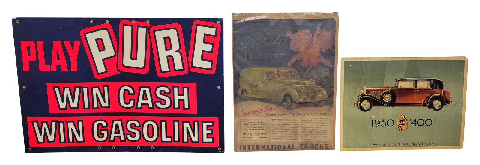 Nash, International Trucks, and Pure Cardboard Signs: Lot of 3 signs includes a 36" x 27" Nash cardboard sign with scuffs, scratches, and tears along the edges. Also a 28" x 37.5" International Trucks poster that appears to be in decent condition with we