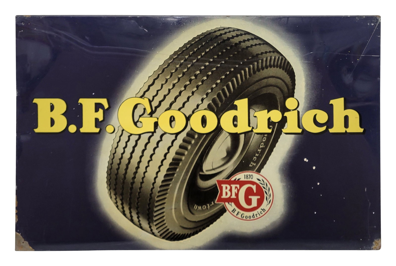 B.F. Goodrich Single Sided Tin Sign: 34.5" x 23" SST sign is mounted on a wood frame. The sign exhibits bright colors and high shine with wear in the field including scuffs, light scratches, small dings, and several spots of errant white