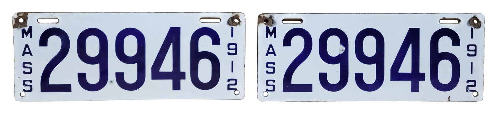 Pair of Massachusetts 1912 Porcelain Automobile License Plates: Lot consists of a pair of 14" x 5.5" porcelain car tags that exhibit excellent color and gloss. One tag has a chip in the field on the "9". Both tags have small chips at the mounting holes. Each tag i
