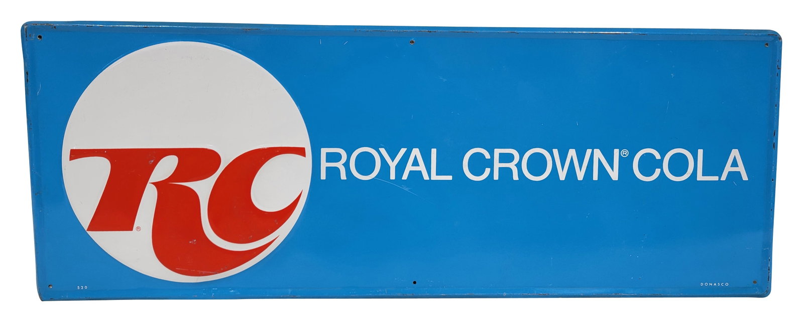 RC Royal Crown Cola Embossed SST Sign: 32" x 12" embossed SST sign exhibits good color and shine with light wear and multiple small scratches in the field. The self framed perimeter has light wear with scratches and small areas of flaked p
