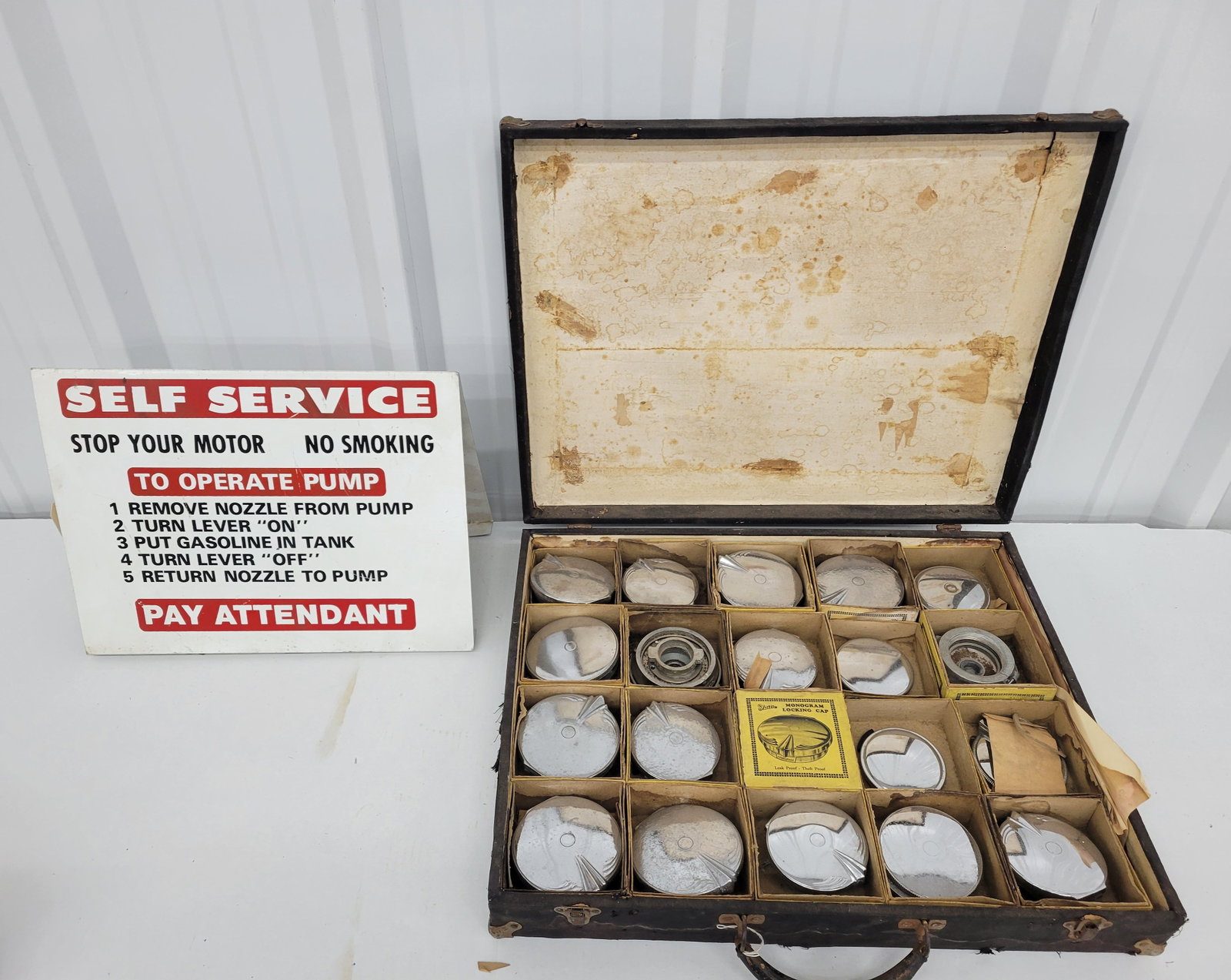 Self Service DST Pump Topper Sign and Faith Radiator Caps: Lot includes a 16" x 11.5" x 8" DST gas station Self Service pump topper sign with light wear on each side including scratches and marks. Also included is case of 20 Faith radiator caps in what appea
