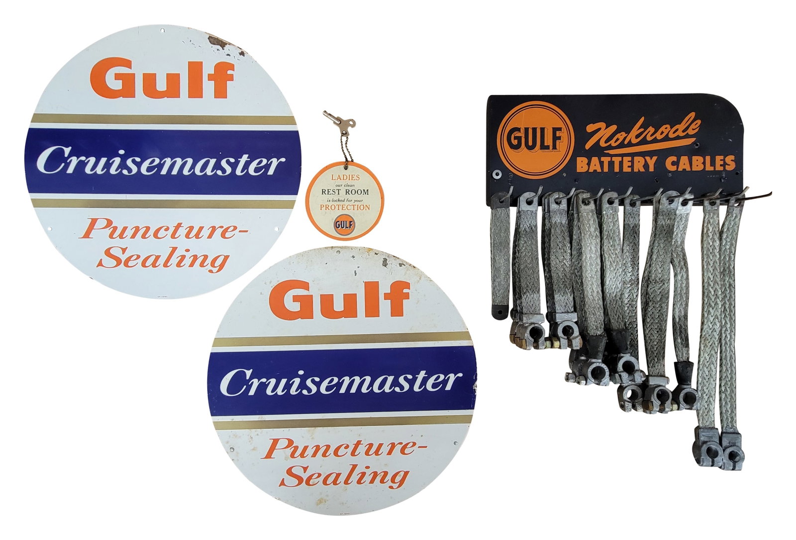 Gulf Battery Cable Rack, Cruisematic Tire Insert Signs, and Gulf Key Fob: Lot of 4 includes a 14" x 21" Gulf Nokrode Battery Cables rack with NOS product. The metal rack displays good color with moderate wear. Also included are a pair of 15.5" SST Gulf tire inserts with fla