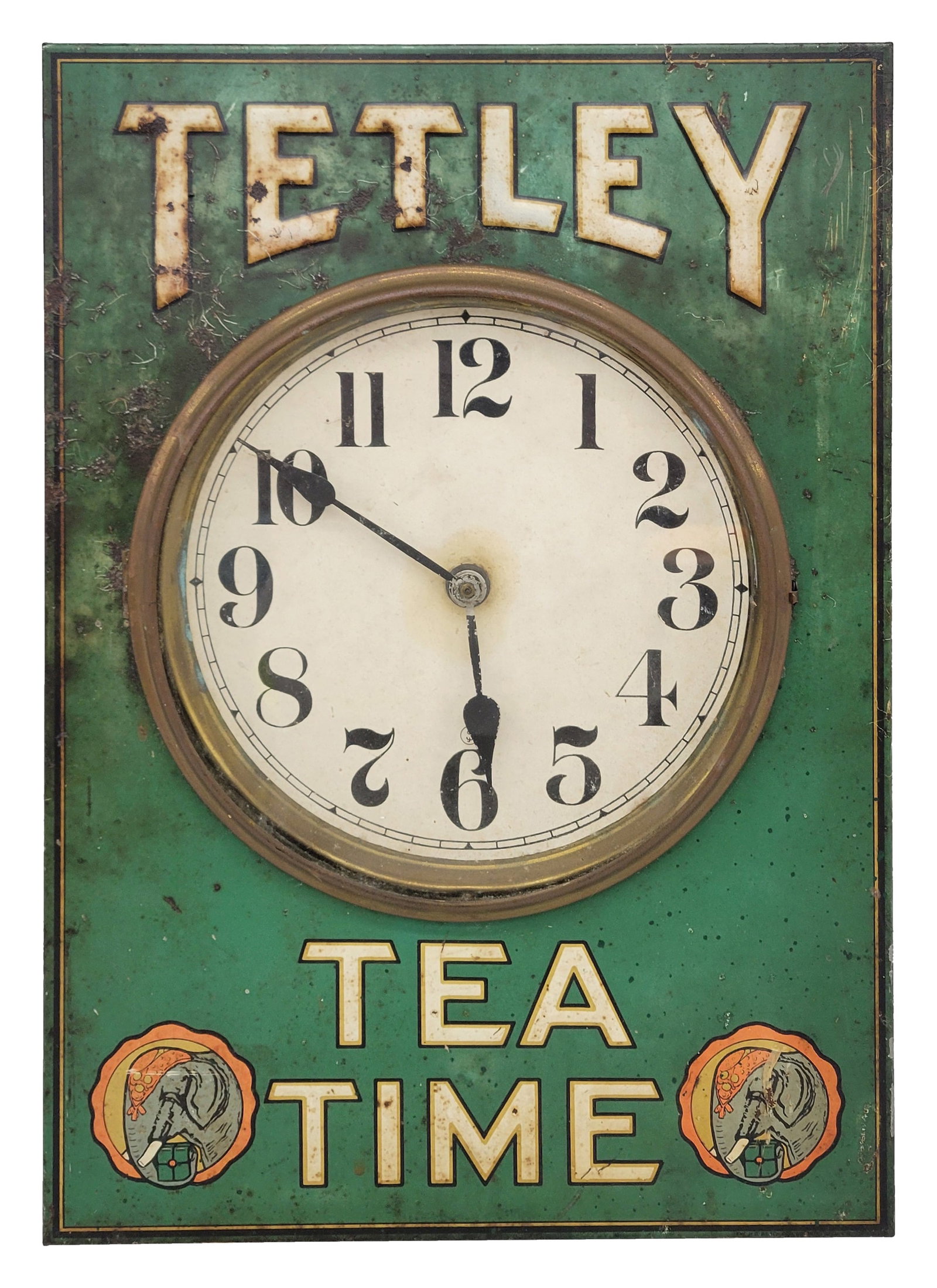 Tetley Tea Time Clock: 14" x 20" x 2" working clock is crafted with a hinged glass front and a metal ring that provides access to the clock hands. It showcases an embossed metal casing with elephant designs in the lower cor