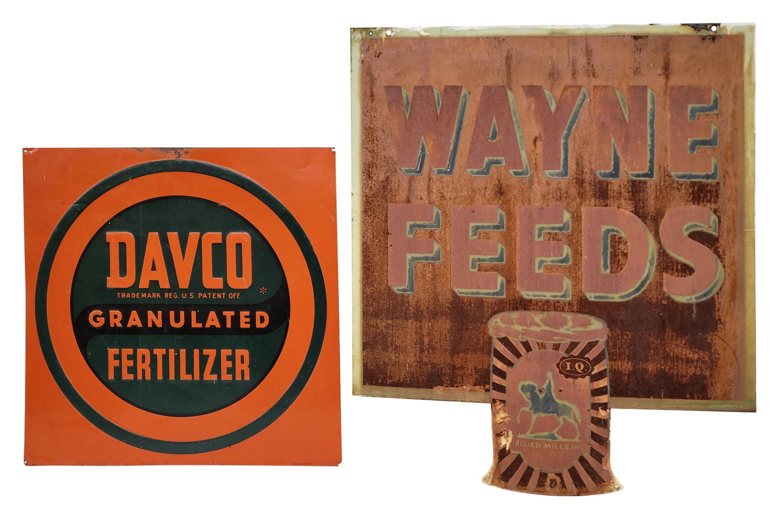 Davco Granulated Fertilizer and Wayne Feeds Signs: Lot of 2 includes 26" x 26" embossed SST sign exhibits good color with moderate wear including scuffs, light scratches, and several small shallow bends. The top edge has an area of flaked paint and su