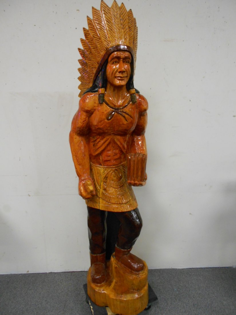 Wooden Cigar Store Indian: 5ft 7in Nice wooden cigar store Indian. Rare pose with bent leg. One feather tip is broken off. Repairable.