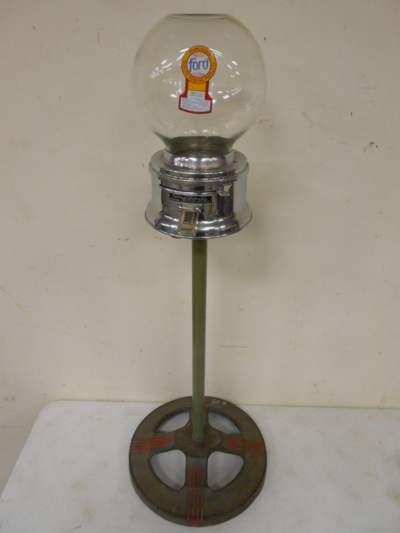 Ford bubble gum machine on deco cast iron base: Ford bubble gum machine on art deco cast iron base.
