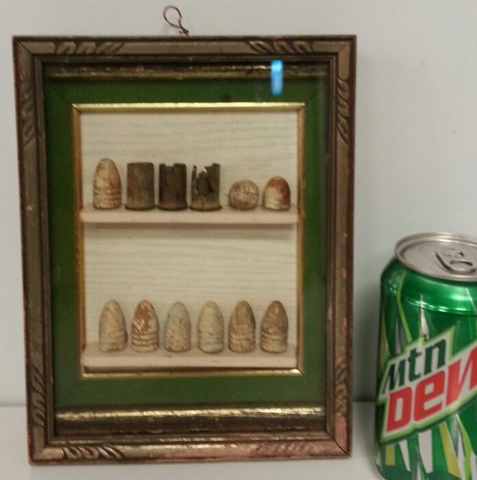 Framed shadow box of Civil War Bullets: Civil war bullets in shadow box. One is Confederate. Actual dug bullets