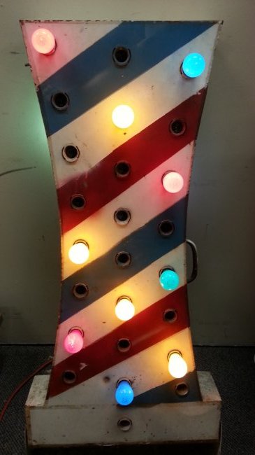 vintage metal baber shop pole sign: 45"h x 12"w x 5"d Painted metal 2 sided barber pole sign with 23 light sockets on each side and a hole at the top for another light. Painted in red white and blue.