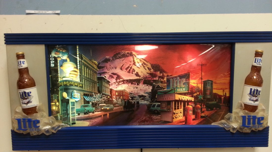 Miller Lite Beer Coast to Coast scrolling light up sign: 39"w x 17.5"h 3d Lite beer bottles on both ends. The sign lights up and scrolls through different scenes.