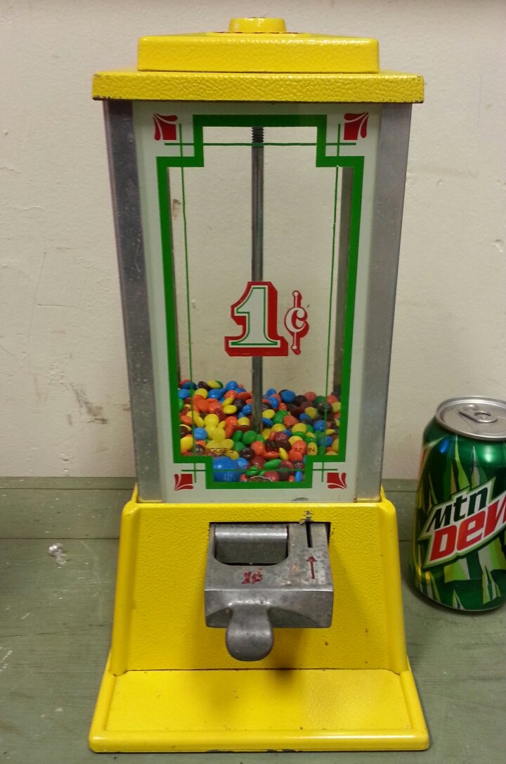 Dean 1 cent candy machine: Yellow candy machine with white, green, and red graphics.