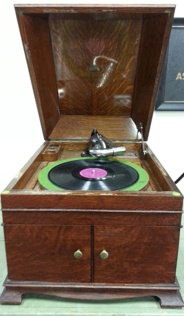Victrola talking machine phonograph: Countertop style Victrola made by Victor Talking Machine Co. Serial #0418070. Graphics under the lid are bright and shiny. Phonograph comes with extra needles. Sounds great and volume is controlled by