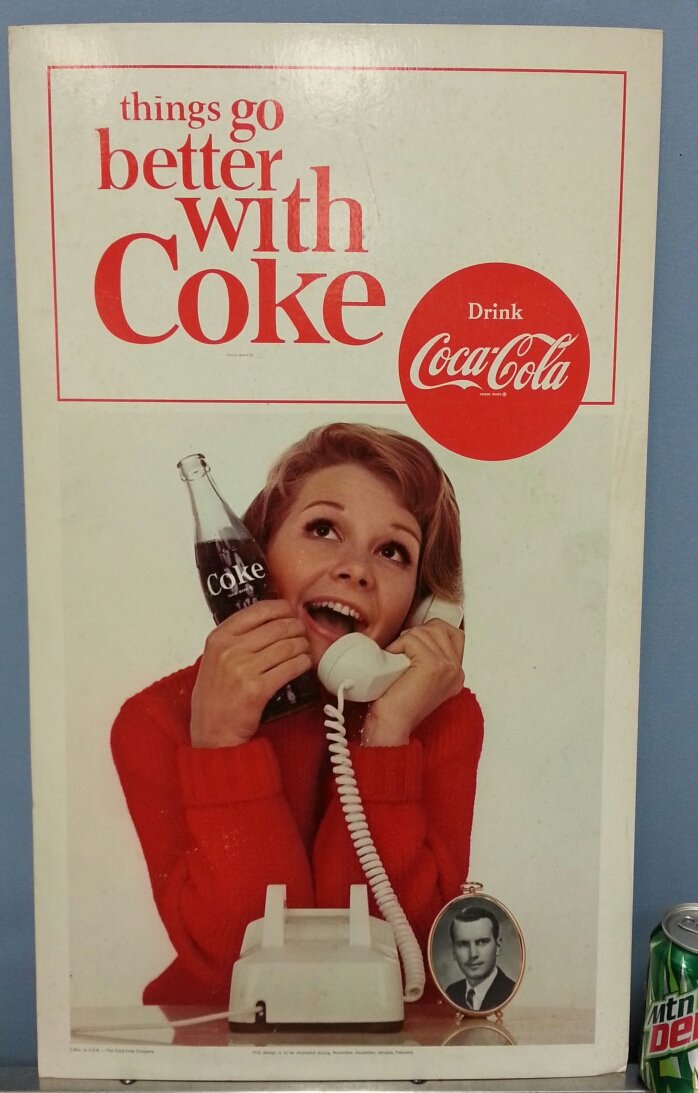 Coca Cola cardboard sign: 16"w x 27"h Cardboard sign with girl talking on the telephone. "Things go better with Coke"