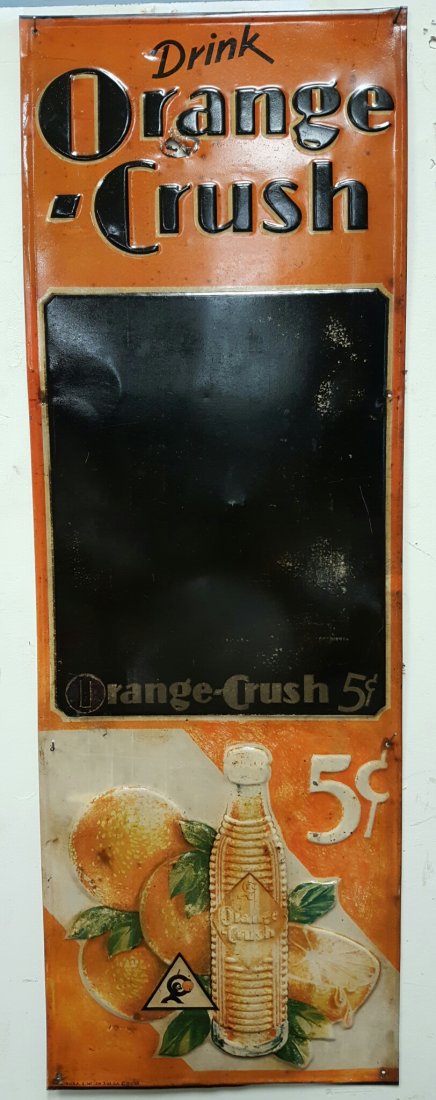 Early embossed Orange Crush Menu Board: 13.5"w x 39"h Orange Crush 5 cent menu board. Orange Crush embossed at top and oranges, bottle, and 5 cents embossed at bottom. Nice graphics of Crushy. Black menu/chalk board in the middle.
