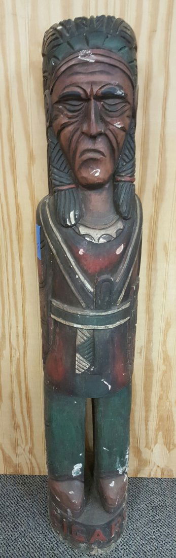 Wood Cigar Store Indian: 47" Wood carved cigar store Indian. Carved with head dress, knife in front, holding cigars, detailed clothes, and Cigars carved at the bottom