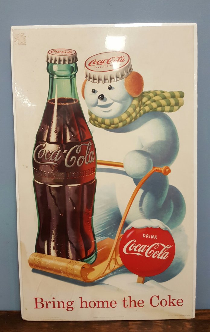 1957 Coca Cola Snowman Cardboard sign: 16"w x 27" Original cardboard sign with a snowman and Coca Cola bottle in a sled. Reads "Bring home the Coke" Comes wrapped in shrink wrap.