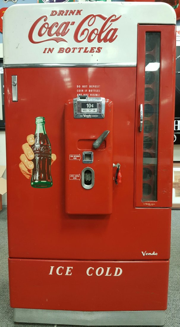 Coca Cola HX110 D Vendo Machine: 1950's Coca Cola Machine Vendo model HX110 D. Glass hinged door on the right side with see through glass. 10 vending choices. Coke bottle in hand decals on all four sides with embossed Drink Coca Cola