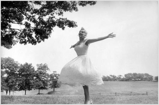 Marilyn Monroe Barefoot and Dancing, Roxbury #3: Description of image: Sam Shaw took several photos of Marilyn one day as she danced freely and happily while barefoot on the 350 acre farm in Roxbury, CT, c. 1957. Sam had a way of bringing out the be